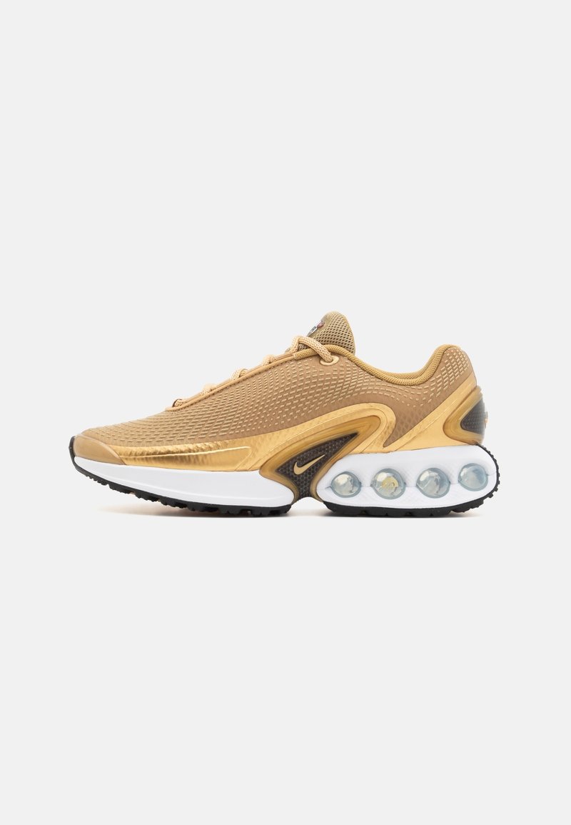 Gold mesh athletic shoe with a rounded toe, cushioned sole, and visible air chambers. Features contrasting black and white accents.