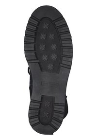 Sort gummisål med dyb, struktureret mønster og fremhævede krydsdesigns. Har solide sider og mærket label.