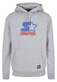 Grå hættetrøje lavet af blødt stof med et stort blå og rødt "STARTER" logo. Den har en forlomma og en hætte med snore.