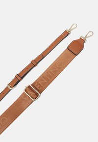 Bruna läder- och tygjusterbara väsksremmar med guldfärgade spännen, en av dem med präglad varunamn-detalj.