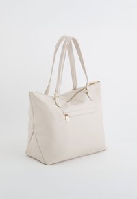 Beige vegane Leder-Tote mit zwei Schulterriemen, Reißverschluss oben und einer Reißverschlusstasche vorne. Glatte Textur mit goldfarbenen Hardware-Akzenten.