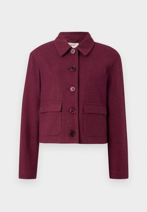 Burgundy cropped jacket made of textured fabric with a pointed collar, five buttons, and two front pockets.