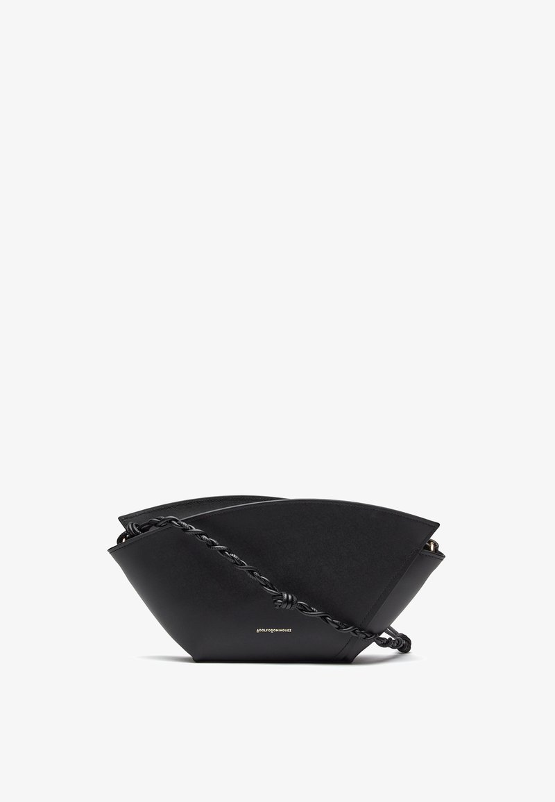 Black leather crossbody bag with angular shape and twisted strap, featuring small gold logo on front center.