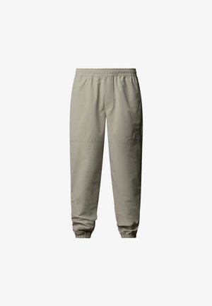 Light beige, elastic-waist joggers with tapered cuffs, made from smooth, water-resistant fabric. Features subtle logo detail.