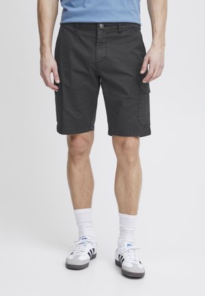 Cargo shorts in dark gray fabric with a flat front, side pockets, and stitched hems. Paired with white socks and sneakers.