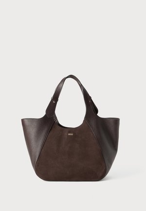 Brown leather tote bag with suede and textured leather sections, wide opening, dual handles, and subtle branding on the front.
