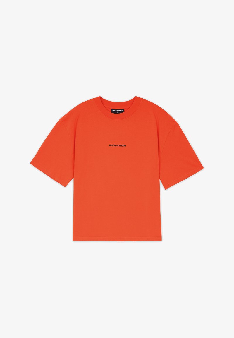 Bright orange short-sleeve t-shirt with "PEGADOR" logo printed in black centered on the chest, round neckline, and relaxed fit.