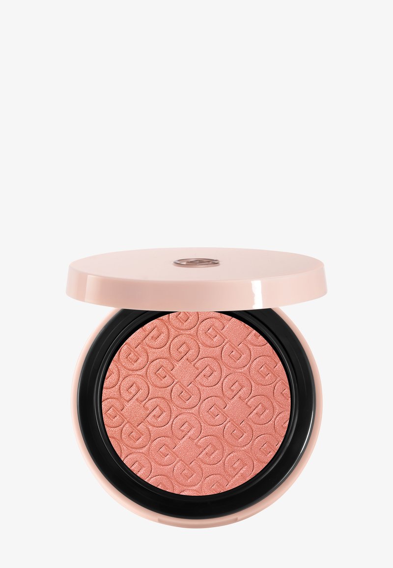 Pudriger Rougepuder in einem runden, hellrosa Kompaktgehäuse. Verfügt über ein strukturiertes, geprägtes Muster in hellem Pfirsich mit einem glänzenden, schwarzen Rand.