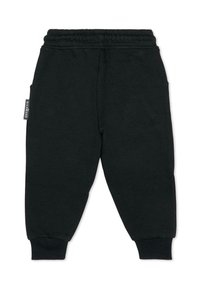 Pantalons de jogging noirs en coton doux, dotés d'une taille élastique, de bords côtelés et de poches latérales. Étiquette de marque minimaliste visible.