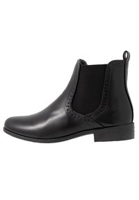 Stivaletto alla caviglia in pelle nera con pannelli laterali elasticizzati, punta arrotondata, perforazioni decorative e tacco basso impilato. Texture liscia e design essenziale.