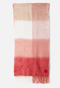Rectangular scarf in ombre shades of red, pink, and white. Made of soft, textured material with fringe edges and a small red label.