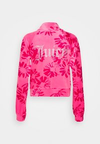 Roze veloursjack met een bloemmotief en het "Juicy"-logo in strass-steentjes op de achterkant. Verkorte pasvorm met lange mouwen en elastische manchetten.