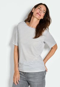 Grau-weiß gestreiftes Kurzarmoberteil mit glatter Textur und rundem Halsausschnitt, kombiniert mit grauen Jeans.