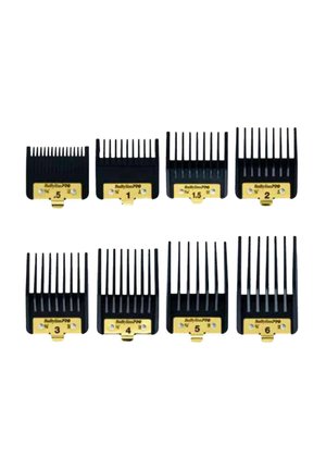 Eight black clipper guard attachments labeled 0.5 to 6 with gold base plates arranged in two rows on white background.