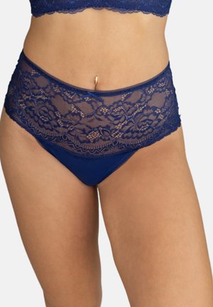 Woman wearing blue lace high-waist panties and matching lace bralette, showing midsection and belly button piercing.
