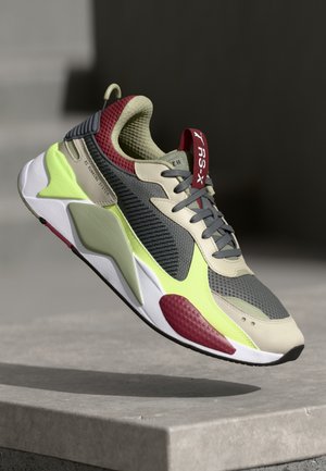 Sneaker with a mesh and synthetic upper, featuring a grey and beige color scheme, neon green accents, and red detailing on the heel tab.