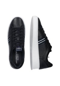 Black leather sneakers with textured surface, white rubber sole, and navy blue accent stripes. Features round toe and lace-up front.