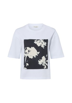 T-shirt blanc à manches courtes avec un carré noir présentant de grandes silhouettes florales blanches à l'avant.
