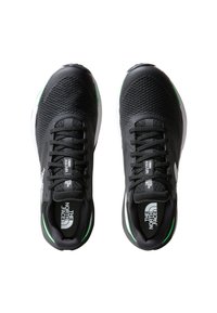 Scarpe sportive nere con tomaia in rete, punta rotonda e accenti verdi. Progettate con chiusura con lacci e suola ammortizzata.