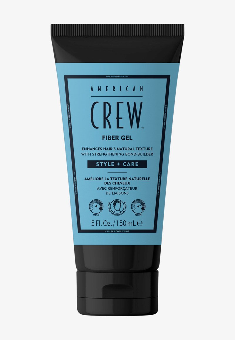 Gel de fibra en un tubo negro y azul de 5 oz. Presenta texto destacado e íconos para fijación, brillo y mejora de textura para cabello de textura media.
