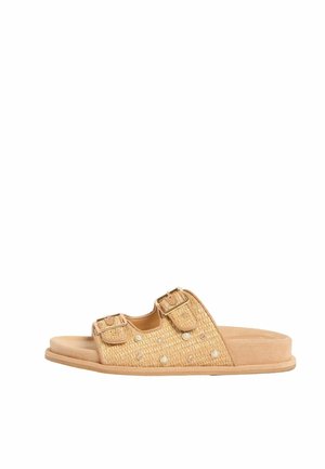 Bézs színű papucs két állítható csatos pánttal, szövött textúrával, valamint apró gyöngy- és strasszköves díszítésekkel a felső részen.