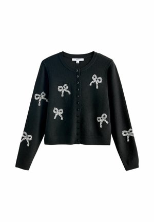 Black buttoned cardigan with silver bow patterns scattered on front and sleeves, featuring a round neckline and long sleeves.