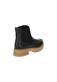 Botín de cuero negro hasta el tobillo con panel lateral elástico, parte superior texturizada y suela de goma beige. Punta redondeada y lengüeta en la parte trasera.