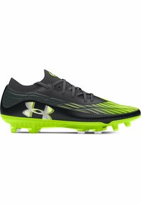 Scarpa da calcio nera e verde con una parte superiore testurizzata, caratterizzata da un design affilato, suola verde brillante e logo Under Armour sul lato.