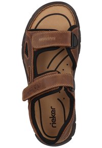 Brown leather sandal with two adjustable straps, cushioned insole, and rubber sole. Features a smooth texture and subtle stitching details.