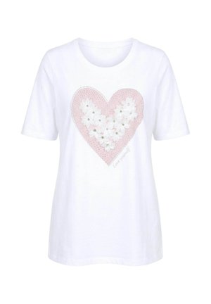 Bílá košile s krátkým rukávem s velkým růžovým srdcem zdobeným bílými květinami a krystaly a textem "Měj se rád" na přední straně.