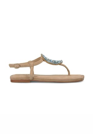 Sandali piatti beige con un accento decorativo di perline blu e argento sulla parte superiore. Dotati di una cinghia alla caviglia regolabile e di una suola liscia.