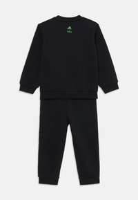 Black Adidas tracksuit featuring a crew neck sweatshirt and matching pants, with green Adidas and Disney logos on the back.