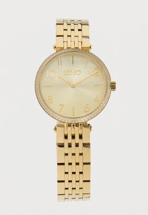 Reloj de pulsera Liu Jo tono dorado con caja redonda, bisel decorado con cristales, esfera minimalista y correa de pulsera metálica con eslabones.