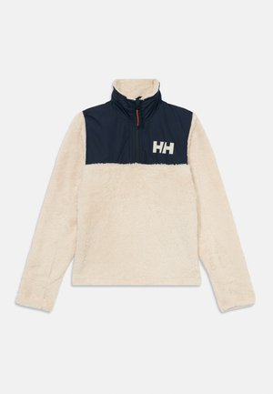Pull en polaire crème avec un panneau poitrine bleu marine, col zippé et logo blanc. Texture douce, longues manches et coupe décontractée.