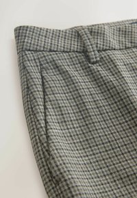 Gray plaid trousers made from textured fabric, featuring a flat front, waist pleats, and a tailored waistband with subtle stitching details.