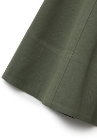 Dark green cotton skirt with a flared design, featuring a smooth texture and visible stitching along the seams.