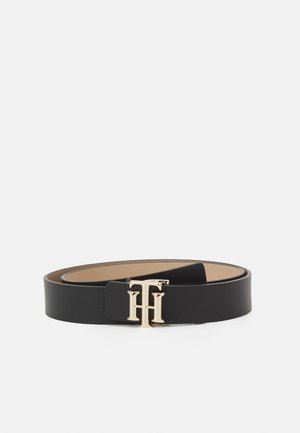 Black leather belt coiled with gold-tone metal logo buckle featuring intertwined letters "T" and "H."