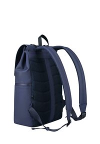 Navy backpack with structured shape, textured fabric on the back, and adjustable straps. Features sleek design and minimal hardware.