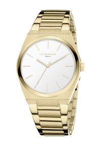 Orologio in metallo dorato con quadrante bianco rotondo, indicatori delle ore minimalisti e bracciale a maglie. Design della cassa esagonale, finitura elegante e lucida.