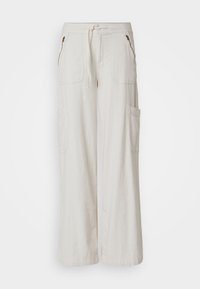 Světlé béžové široké kalhoty vyrobené z texturované látky, s dvěma předními kapsami a elastickým pasem na šňůrku pro nastavitelné nošení.