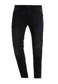 Vaqueros negros de mezclilla con un corte ajustado, con detalles desgastados y una textura ligeramente descolorida. Diseño estándar de cinco bolsillos.