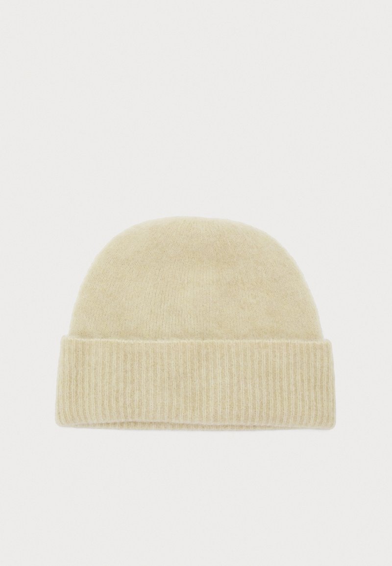 Strickmütze in hellem Beige mit einer weichen Textur, abgerundetem Oberteil und geripptem Bündchen. Schlichtes Design, das zu verschiedenen Outfits passt.