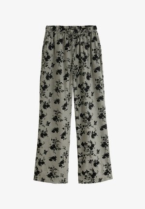 Pantalon à carreaux noir et blanc avec un motif floral, équipé d'une taille élastique et de jambes larges pour un ajustement confortable.