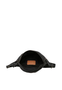 Black leather waist bag with open main zip compartment showing black interior and brown rectangular patch inside.
