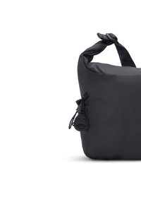 Borsa a spalla in nylon nero con manico annodato, tasca con zip dotata di un tirante rotondo con un design di faccia, e una forma semplice e minimalista.