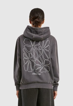 Gray hoodie with a large white floral design on the back, featuring a script text "Take it easy" at the hem. Soft fabric, relaxed fit.
