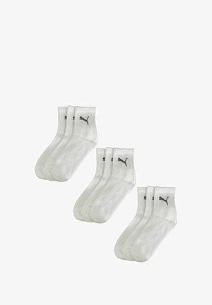 White cotton crew socks, featuring a ribbed cuff and small black Puma logo. Sold in a pack of four with a smooth, soft texture.