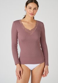 Long-sleeve top in mauve with a textured pattern, featuring a v-neck adorned with intricate lace detailing. Smooth fabric finish.