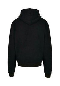 Svart huvtröja med avslappnad passform, med en solid textur och ribbade ärmslut och fåll. Bakvy visar en sömlös design utan mönster.