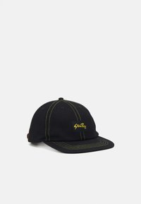 Black baseball cap made of cotton with yellow stitching. Features a square logo patch on the front and a curved brim.